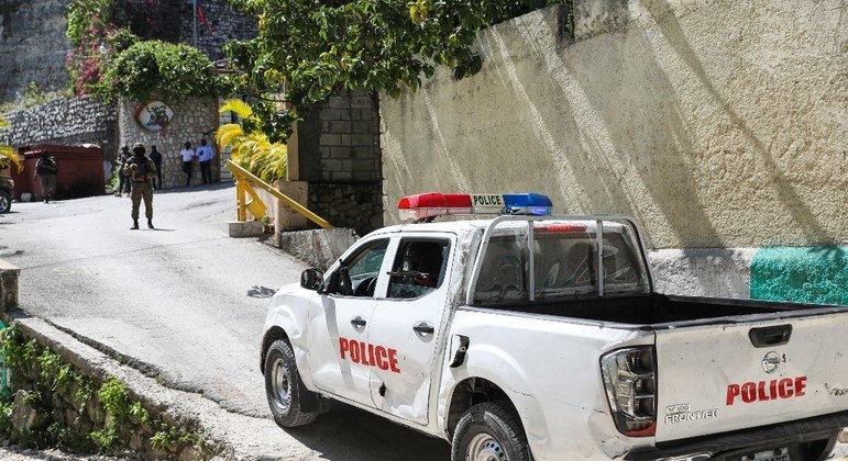 Viatura policial fecha a entrada da residência presidencial em Porto Príncipe, local do crime
