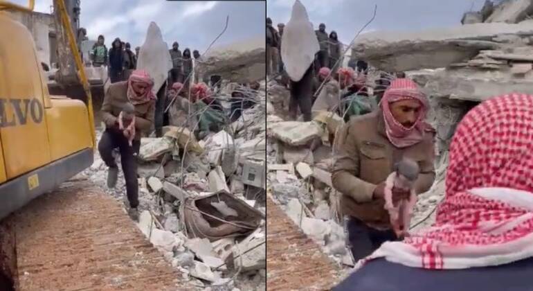 Homem resgatando bebê nascido em escombros