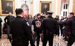 Police confront supporters of President Donald Trump as they demonstrate on the second floor of the U.S. Capitol near the entrance to the Senate after breaching security defenses, in Washington, U.S., January 6, 2021. REUTERS