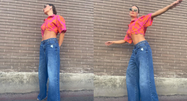 Isis Valverde preferiu um lookinho básico, com uma camisa rosa e laranja e óculos de sol. Além disso, ela usou uma calça larguinha jeans de cintura baixa