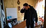 Jovem confere o que sobrou de sua casa após ataque russo em Kiev