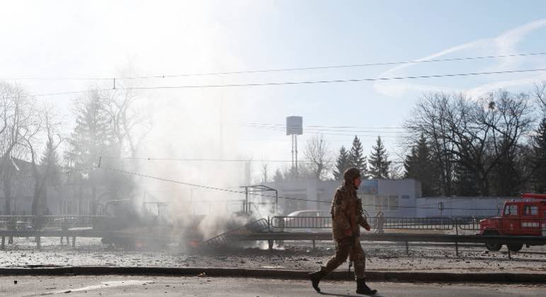 Militar ucraniano passa por veículo danificado, em local de combate com tropas russas em Kiev