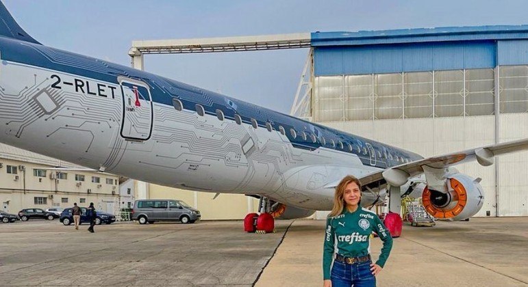 Leila Pereira posa ao lado do avião que será utilizado pelo Palmeiras
