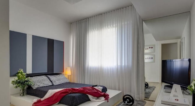 Loft com quarto de casal com espelho na parede Projeto de Denise Macedo