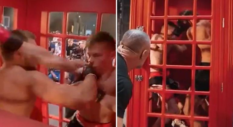Lutadores disputam em cabine telefônica na Rússia
