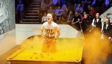 Manifestante invade campeonato mundial de sinuca e joga pó laranja por toda a mesa