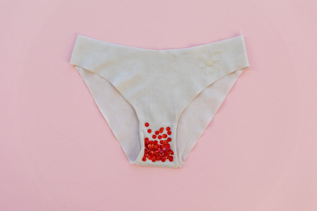 Tema da menstruação. protetores de calcinha femininos com sangue em fundo  rosa. vista do topo. postura plana