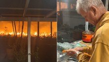 Morador descasca cenouras a poucos metros de incêndio violento