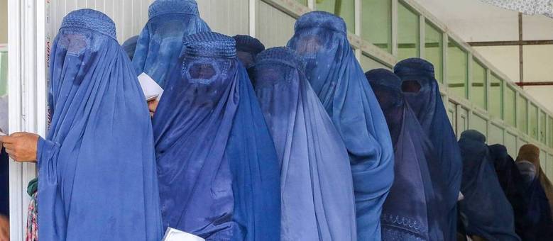Afegãs com hijab saem à rua sob regime Talibã, em imagem de agosto deste ano (Shafiullah Kakar / AFP - 06.08.2023)