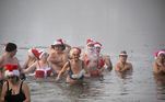 Members of the Berliner Seehunde (Berlin seals) swimming club take their traditional Christmas bath at the Oranke lake on December 25, 2022 in Berlin.
