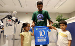 Homem ao lado de duas crianças posa com a camisa do jogador, que se soma a outros craques que brilhavam no continente europeu e que foram seduzidos pelas altas cifras sauditas, como CR7, Benzema e Firmino