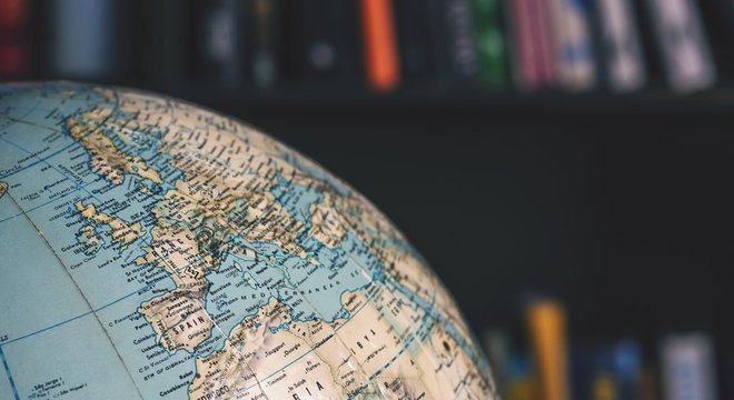 Objeto em formato de globo terrestre na frente de livros