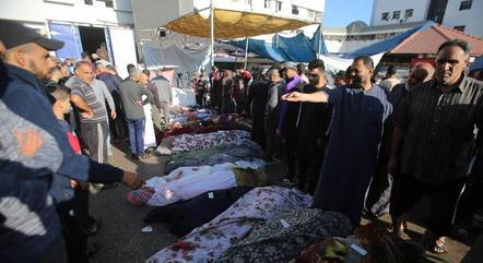 Pessoas reúnem-se em torno de corpos em Gaza