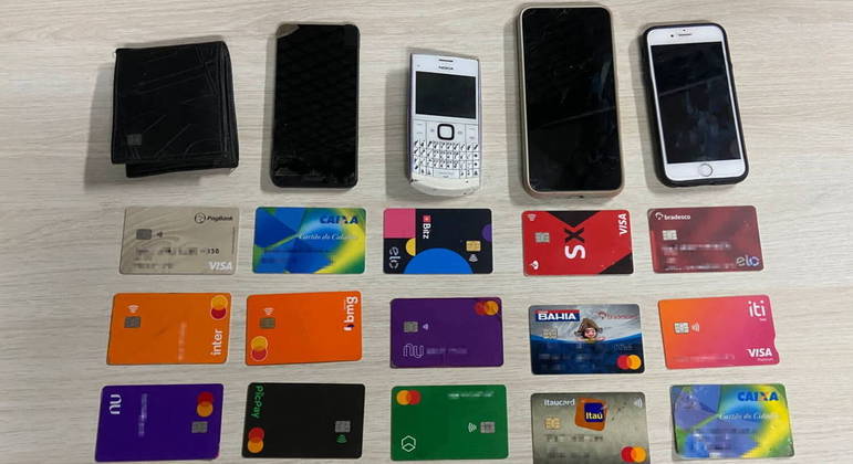 Celulares e cartões apreendidos pela polícia com os suspeitos presos