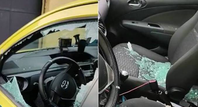 Taxista mostra vidros do carro destruídos em tiroteio na comunidade