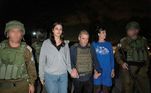Judith Tai Raanan and her daughter Natalie Shoshana Raanan, U.S. citizens who were taken as hostages by Palestinian Hamas militants, walk while holding hands with Brig.-Gen. (Ret.) Gal Hirsch, Israel's Coordinator for the Captives and Missing, after they were released by the militants, in response to Qatari mediation efforts, in this handout picture obtained by Reuters on October 20, 2023. Government of Israel/Handout via REUTERS THIS IMAGE HAS BEEN SUPPLIED BY A THIRD PARTY. FACES BLURRED AT SOURCE