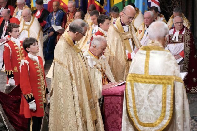Charles 3º ajoelhado durante cerimônia na Abadia de Westminster