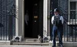Larry the resident cat sits on the steps of Downing Street next to a police officer during a Government reshuffle in Downing Street, central London, England, 11 May 2015. British Prime Minister David Cameron appointed his first Conservative government after the Conservative party's narrow victory in the general election on 07 May 2015. EPA/WILL OLIVER