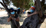 People take part in a campaign by Israel's Nature and Parks Authority calling on Israelis to join sightseeing tours and find comfort in tree hugging amid a spike in the coronavirus disease (COVID-19), in Apollonia National Park, near Herzliya, Israel July 7, 2020. Picture taken July 7, 2020. REUTERS/Ronen Zvulun TPX IMAGES OF THE DAY