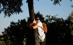 A woman takes part in a campaign by Israel's Nature and Parks Authority calling on people to join sightseeing tours and find comfort in tree hugging amid a spike in the coronavirus disease (COVID-19), in Jerusalem July 9, 2020. Picture taken July 9, 2020. REUTERS/Ronen Zvulun