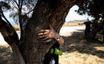 People take part in a campaign by Israel's Nature and Parks Authority calling on Israelis to join sightseeing tours and find comfort in tree hugging amid a spike in the coronavirus disease (COVID-19), in Apollonia National Park, near Herzliya, Israel July 7, 2020. Picture taken July 7, 2020. REUTERS/Ronen Zvulun