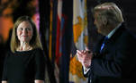 
Judge Amy Coney Barrett looks over at U.S. President Donald Trump as he stands behind a teleprompter before Barrett is sworn in to serve as an associate justice of the U.S. Supreme Court on the South Lawn of the White House in Washington, U.S., October 26, 2020. REUTERS/Tom Brenner
