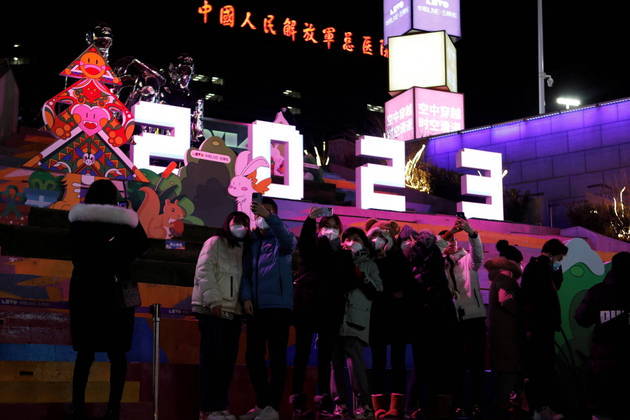 People pose for pictures with a 2023 installation at a shopping complex on New Year's Eve, amid the coronavirus disease (COVID-19) outbreak in Beijing, China December 31, 2022. REUTERS/