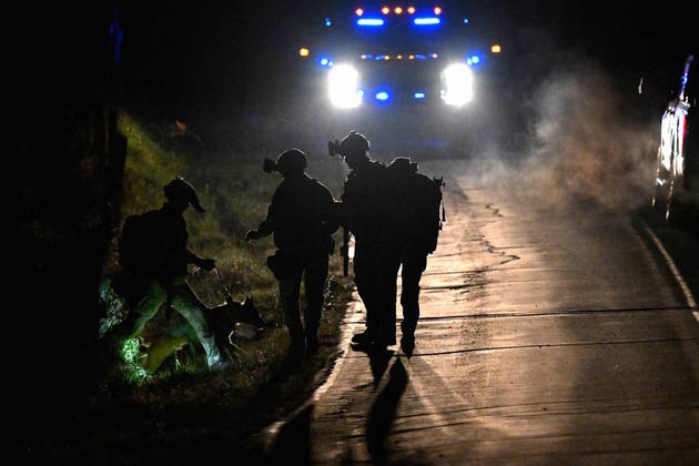 Law enforcement personnel work surround a house in Bowdoin as they search for the suspect in the mass shootings in Lewiston, Maine, U.S., October 26, 2023. REUTERS