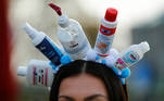 A carnival reveller wears a hat made of disinfection bottles as the traditional celebrations of the start of the famous Cologne carnival season is officially cancelled due to the spread of the coronavirus disease (COVID-19) in Cologne, Germany, November 11, 2020. REUTERS/Thilo Schmuelgen