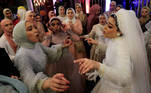Bride Hager Yasser dances with guests during her traditional wedding celebration at the outdoor Grand Palace villa in Queisna, as Egyptian government only allows outdoor events amid the coronavirus disease (COVID-19) pandemic, in Egypt's northern Nile Delta province of Menoufia, Egypt November 4, 2020. REUTERS/Amr Abdallah Dalsh TPX IMAGES OF THE DAY