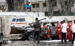  
A police officer keeps watch as Red Crescent workers remove the body of a victim at the scene of a suicide car bomb explosion near the president's residence, in Mogadishu, Somalia, September 25, 2021. REUTERS/Feisal Omar TPX IMAGES OF THE DAY
