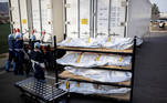 El Paso County Medical Examiner's Office staff lock-up the mobile morgues before moving bodies that are in bags labeled "Covid" from refrigerated trailers into the morgue office amid the coronavirus disease (COVID-19) outbreak, in El Paso, Texas, U.S. November 23, 2020. REUTERS/Ivan Pierre Aguirre TPX IMAGES OF THE DAY