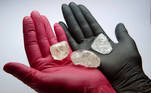 An employee shows gem-quality stones, including a rare 242-carat rough diamond that will be offered at the 100th international auction of Russian state-controlled diamond producer Alrosa, during a presentation in Moscow, Russia February 25, 2021. The diamond is one of the biggest gem-quality stones Alrosa has mined this century, the company said. Picture taken February 25, 2021. REUTERS/Tatyana Makeyeva TPX IMAGES OF THE DAY