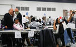 Poll workers pose as votes continue to be counted at the TCF Center the day after the 2020 U.S. presidential election, in Detroit, Michigan, U.S., November 4, 2020. REUTERS/Shannon Stapleton