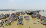 Buildings and farmlands are seen partially submerged in floodwaters following heavy rainfall in Poyang county of Jiangxi province, China July 17, 2020. China Daily via REUTERS ATTENTION EDITORS - THIS IMAGE WAS PROVIDED BY A THIRD PARTY. CHINA OUT.