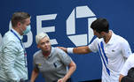 Sep 6, 2020; Flushing Meadows, New York, USA; Novak Djokovic of Serbia and a tournament official tend to a linesperson who was struck with a ball by Djokovic against Pablo Carreno Busta of Spain (not pictured) on day seven of the 2020 U.S. Open tennis tournament at USTA Billie Jean King National Tennis Center. Mandatory Credit: Danielle Parhizkaran-USA TODAY Sports/File Photo TPX IMAGES OF THE DAY SEARCH 'POY SPORTS' FOR THIS STORY. SEARCH 'REUTERS POY' FOR ALL BEST OF 2020 PACKAGES