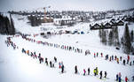 Skiers are separated in an adapted queueing lift system to reduce the spread of the coronavirus disease (COVID-19), in Are, Sweden December 30, 2020. A sign reads "Keep a ski pole distance". TT News Agency/Pontus Lundahl via REUTERS ATTENTION EDITORS - THIS IMAGE WAS PROVIDED BY A THIRD PARTY. SWEDEN OUT. NO COMMERCIAL OR EDITORIAL SALES IN SWEDEN.