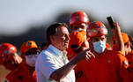 Brazil's President Jair Bolsonaro poses for a photo with firefighters before they depart for a rescue mission in Haiti, at Brasilia Air Base in Brasilia, Brazil August 22, 2021. REUTERS/Adriano Machado