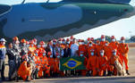 Brazil's President Jair Bolsonaro poses for a photo with firefighters before they depart for a rescue mission in Haiti, at Brasilia Air Base in Brasilia, Brazil August 22, 2021. REUTERS/Adriano Machado