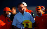 Brazil's President Jair Bolsonaro poses for a photo with firefighters before they depart for a rescue mission in Haiti, at Brasilia Air Base in Brasilia, Brazil August 22, 2021. REUTERS/Adriano Machado
