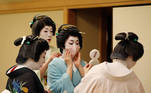 Senior geisha help Koiku put on a protective face mask to have a portrait photo taken of her wearing one for Reuters, before working at a party being hosted by customers, where she will entertain with other geisha, at Asada, a luxury Japanese restaurant, during the coronavirus disease (COVID-19) outbreak, in Tokyo, Japan, June 23, 2020. REUTERS/Kim Kyung-Hoon SEARCH "GEISHA COVID-19" FOR THIS STORY. SEARCH "WIDER IMAGE" FOR ALL STORIES.