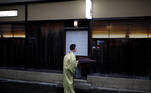 Koiku, who is a geisha, folds a traditional umbrella made out of oli paper, as she arrives at a restaurant where she will work at a party hosted by her customers, where she will entertain, during the coronavirus disease (COVID-19) outbreak, in Tokyo, Japan, July 13, 2020. REUTERS/Kim Kyung-Hoon SEARCH "GEISHA COVID-19" FOR THIS STORY. SEARCH "WIDER IMAGE" FOR ALL STORIES.