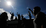 People raise their fists as they cheer to other marchers from a restaurant roof during a "We Want to Live" march and protest against racial inequality in the aftermath of the death in Minneapolis police custody of George Floyd, in Seattle, Washington, U.S. June 7, 2020. REUTERS/Lindsey Wasson