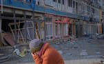 A local resident reacts as she walks on an empty street near a building damaged by a Russian military strike, as Russia's attack on Ukraine continues, in the front line city of Bakhmut, Ukraine February 24, 2023. REUTERS/Alex Babenko TPX IMAGES OF THE DAY