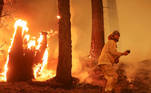 A firefighter continues to hold the line of the Dixie Fire near Taylorsville, California, U.S., August 10, 2021. REUTERS/David Swanson TPX IMAGES OF THE DAY