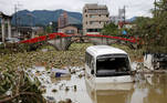A broken bridge is seen in the back, as an overturned vehicle and a partially submerged bus are pictured in floodwaters caused by torrential rain in Hitoyoshi, Kumamoto Prefecture, southwestern Japan, July 8, 2020. REUTERS/Kim Kyung-Hoon TPX IMAGES OF THE DAY