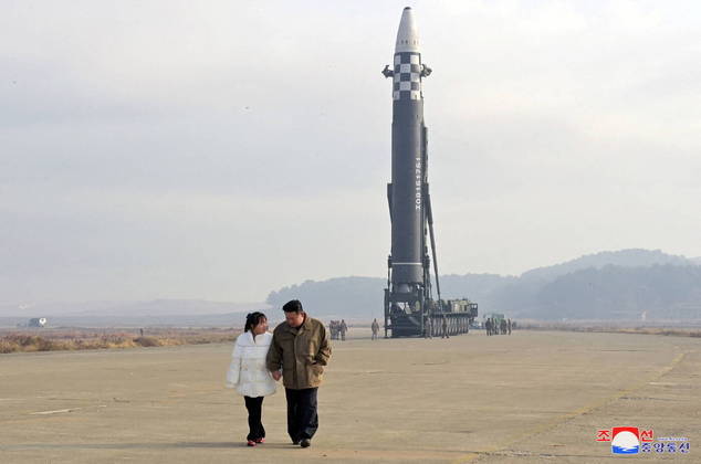 FILE PHOTO: North Korean leader Kim Jong Un, along with his daughter, walks away from an intercontinental ballistic missile (ICBM) in this undated photo released on November 19, 2022 by North Korea's Korean Central News Agency (KCNA). KCNA via REUTERS/File Photo