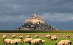 A flock of sheep graze in front of the iconic Mont-Saint-Michel in the French western region of Normandy, France, October 21, 2020. REUTERS/Pascal Rossignol