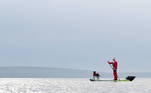 9 - A man dressed as Santa Claus paddles on a board with his dog in Galway Bay amid the spread of the coronavirus disease (COVID-19) pandemic, in Galway, Ireland, December 22, 2020. REUTERS/Clodagh Kilcoyne TPX IMAGES OF THE DAY