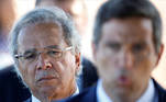 FILE PHOTO: Brazil's Economy Minister Paulo Guedes listens to Brazil's Central Bank President Roberto Campos Neto, as he leaves Alvorada Palace in Brasilia, Brazil April 27, 2020. REUTERS/Ueslei Marcelino/File Photo